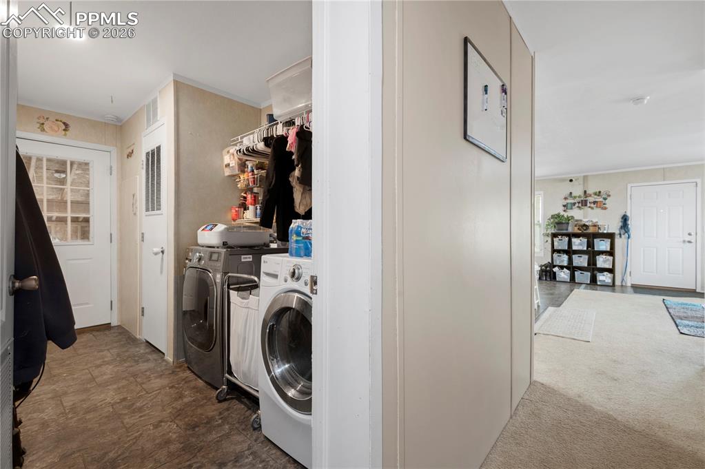 8395 Commanche Road Colorado Springs, CO 80926 - Photo 13 of 29 a view of a bedroom with washer and dryer