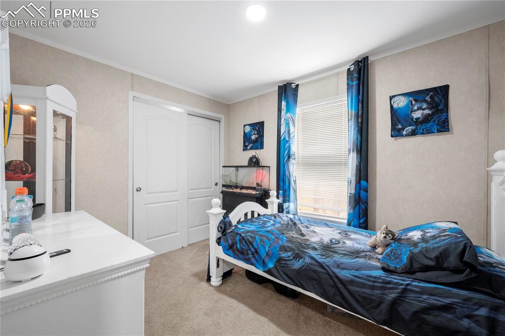 8395 Commanche Road Colorado Springs, CO 80926 - Photo 15 of 29 a bedroom with a bed and a table