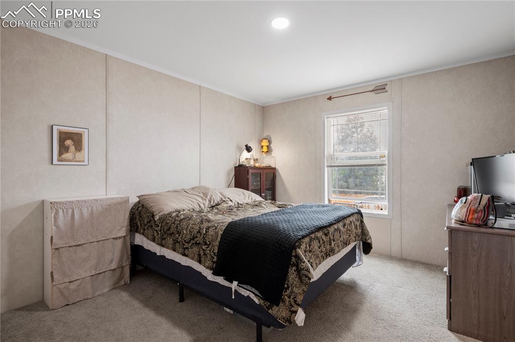 8395 Commanche Road Colorado Springs, CO 80926 - Photo 17 of 29 a bedroom with a bed and a window