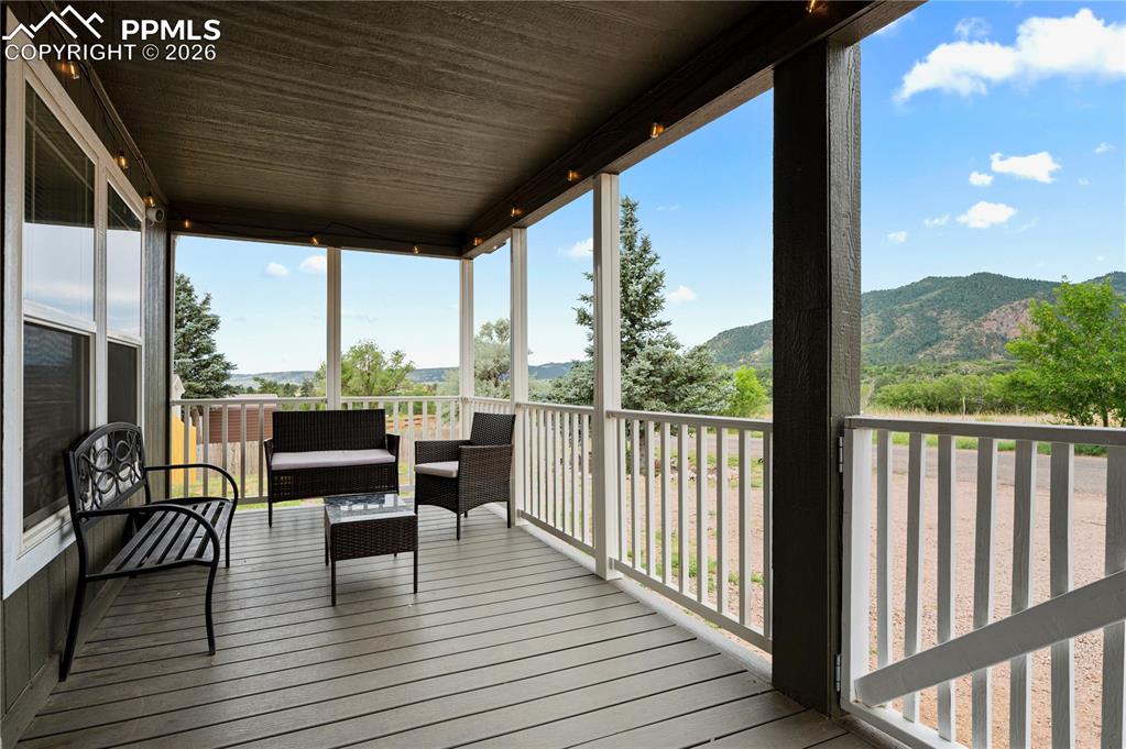 8395 Commanche Road Colorado Springs, CO 80926 - Photo 3 of 29 a view of a chairs and table on the wooden deck