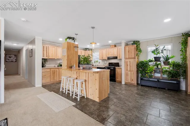 a kitchen with white cabinets and refrigerator