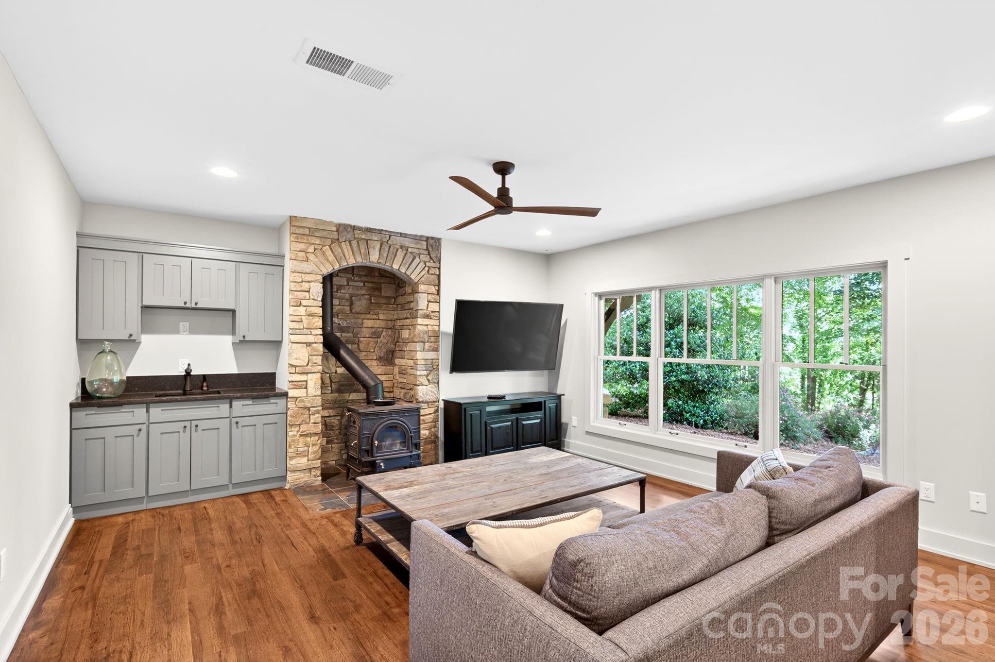 235 Bull Creek Road Asheville, NC 28805 - Photo 26 of 47 a living room with furniture and a flat screen tv