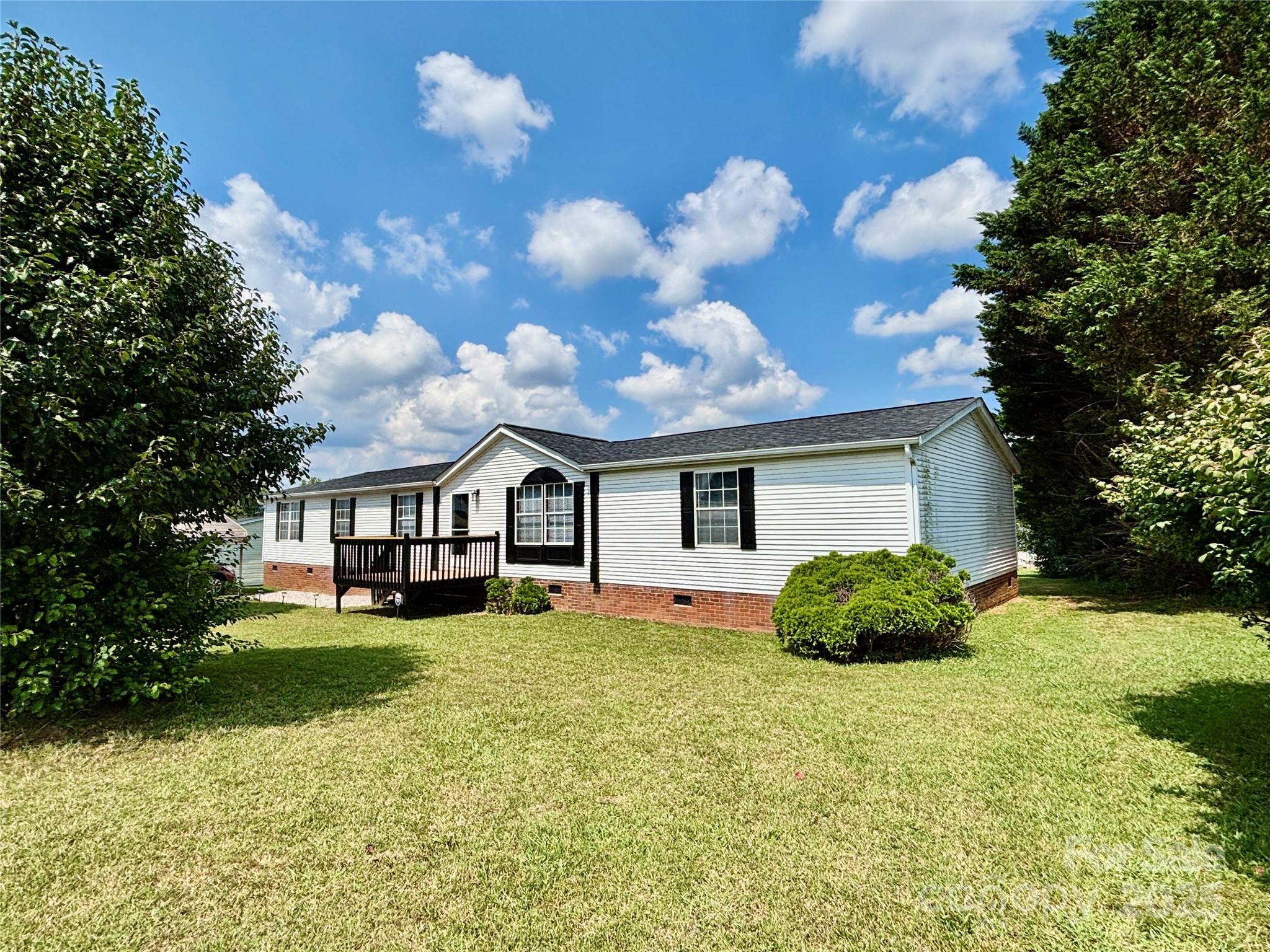 a house view with a sitting space and garden
