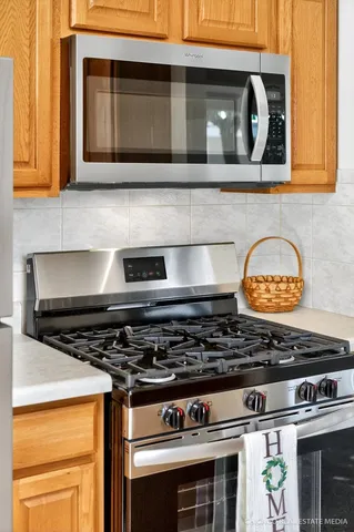 a stove top oven sitting inside of a kitchen