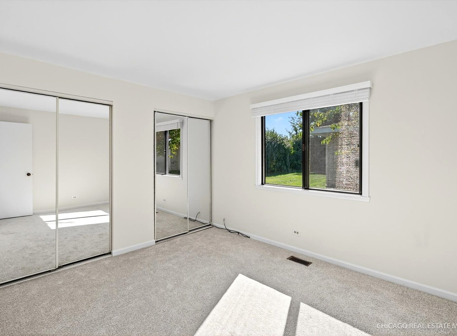 1069 Mohegan Lane Schaumburg, IL 60193 - Photo 15 of 31 an empty room with windows and closet
