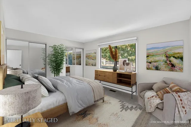 a bedroom with a bed and large windows