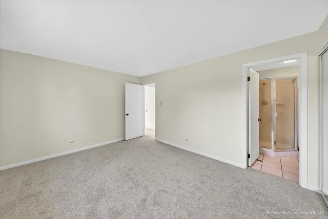 a view of an empty room and closet area