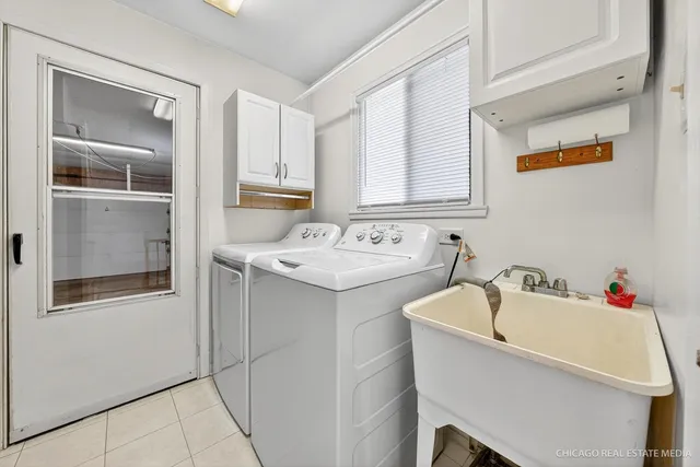 a utility room with a sink dryer and washer