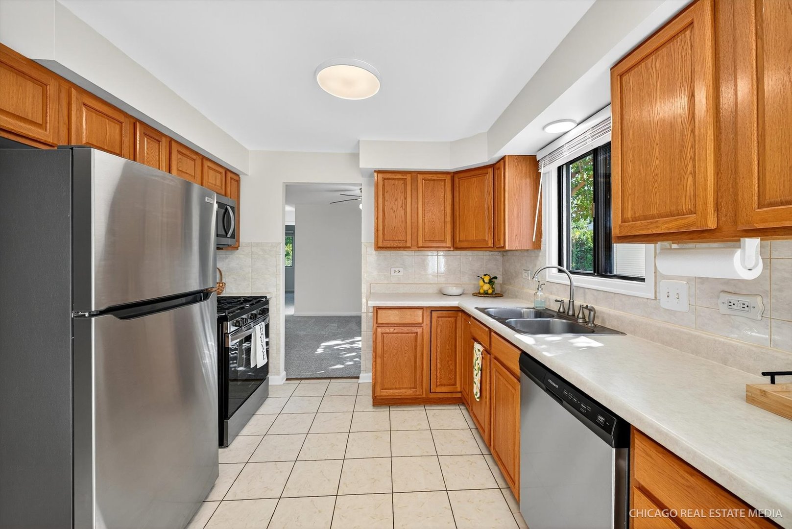 1069 Mohegan Lane Schaumburg, IL 60193 - Photo 6 of 31 a kitchen with a refrigerator a sink and cabinets