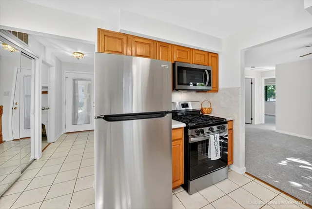a kitchen with stainless steel appliances granite countertop a refrigerator stove and microwave