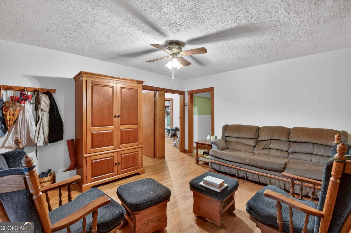 6 Old Aska Curve Blue Ridge, GA 30513 - Photo 14 of 26 a living room with furniture a ceiling fan and a rug