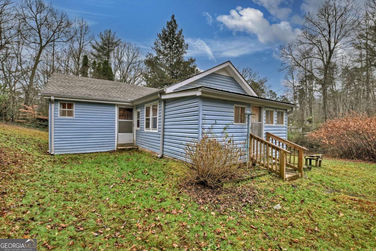 6 Old Aska Curve Blue Ridge, GA 30513 - Photo 4 of 26 a backyard of a house with plants and large tree