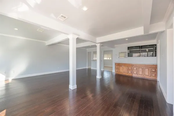 a view of a room with wooden floor