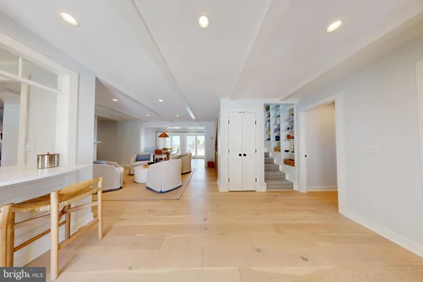 a living room with furniture and kitchen view