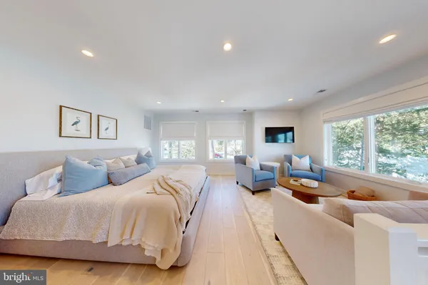 a large bedroom with a large bed and furniture