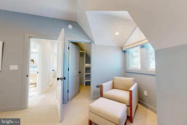 a hallway with a couch and a window