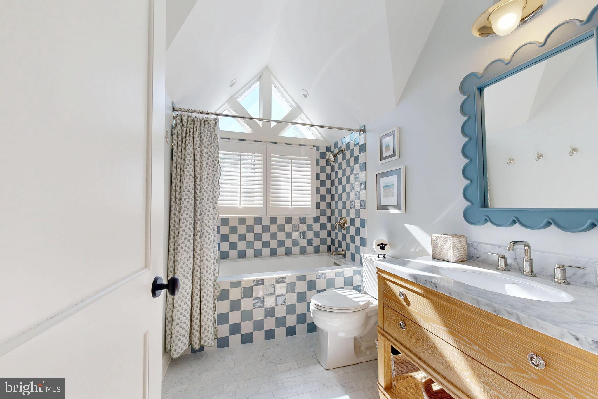601 Cove Road St. Michaels, MD 21663 - Photo 17 of 39 a bathroom with a granite countertop sink mirror vanity and toilet