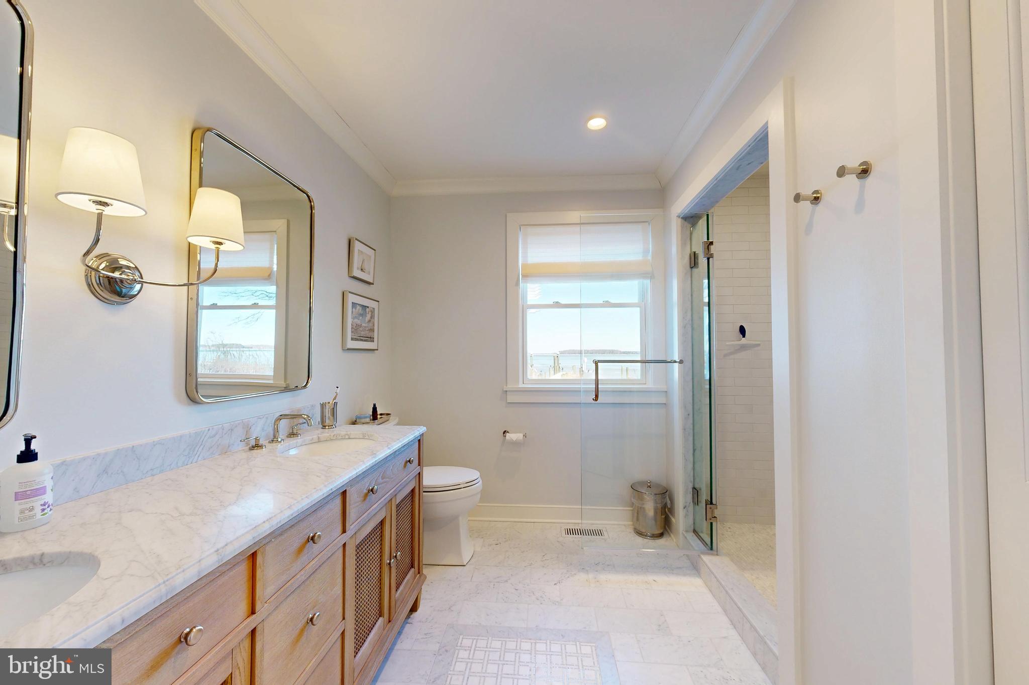 601 Cove Road St. Michaels, MD 21663 - Photo 25 of 39 a bathroom with a double vanity sink toilet and shower