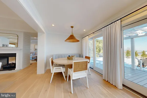 a kitchen with kitchen island stainless steel appliances a stove refrigerator sink and cabinets