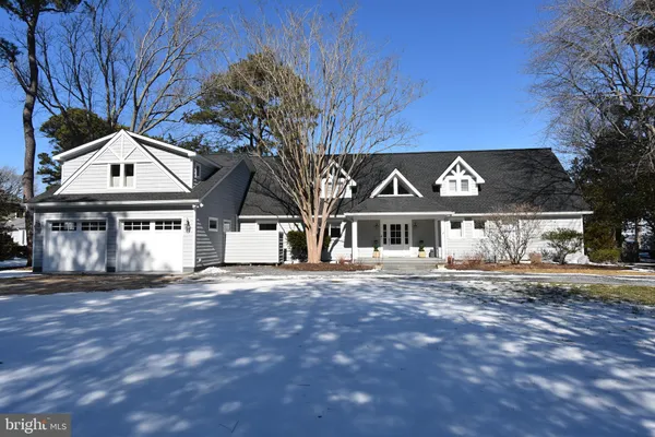a front view of a building with a garden