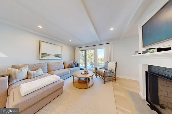 a living room with furniture large window and flat screen tv