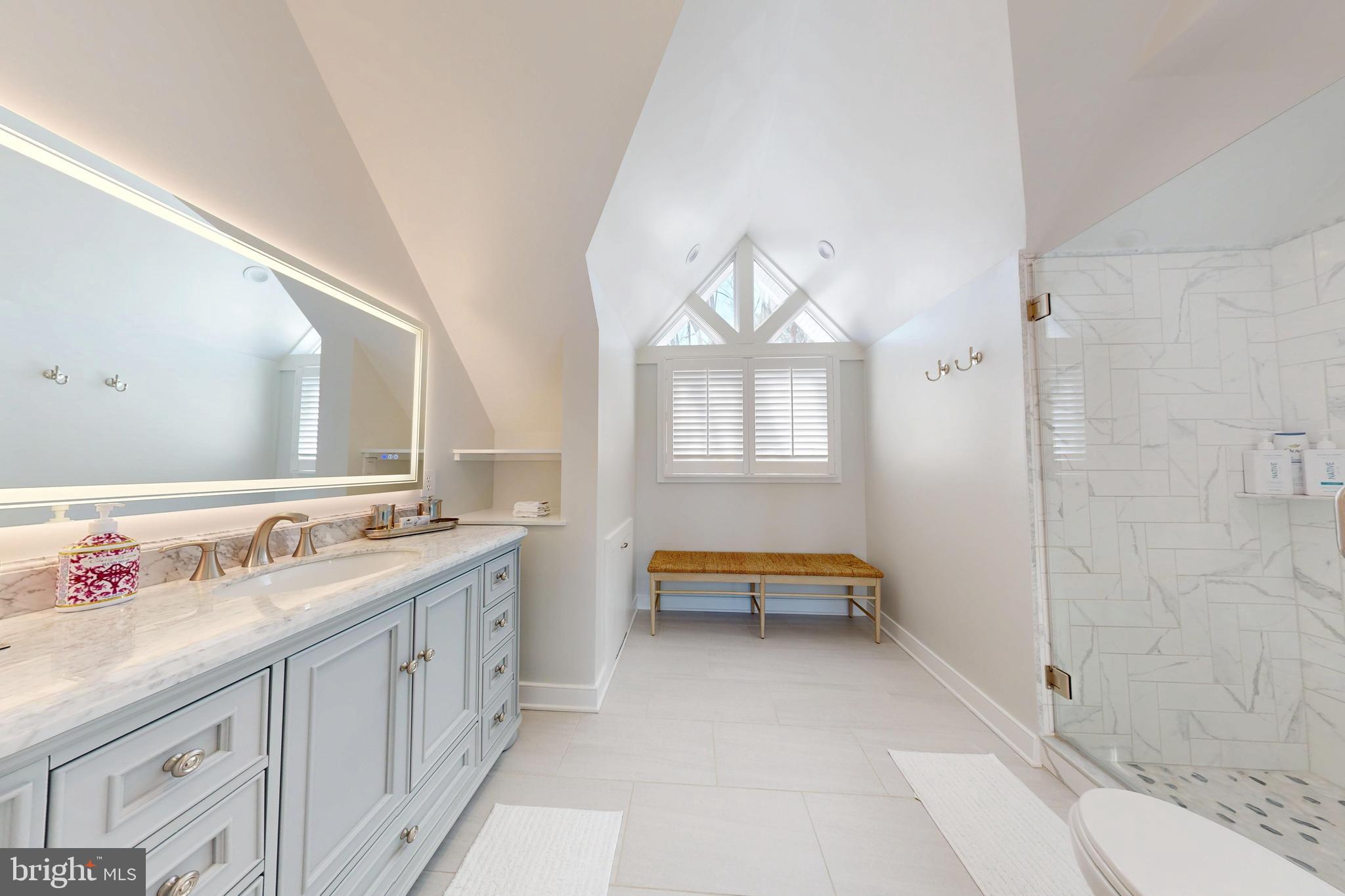 601 Cove Road St. Michaels, MD 21663 - Photo 10 of 39 a view of a bathroom with double vanity sink and a mirror