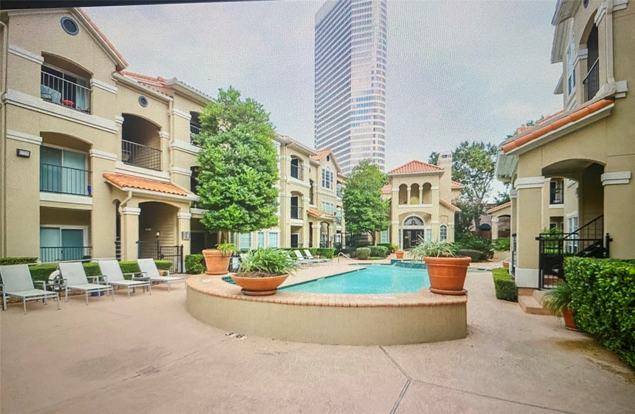 3231 Allen Parkway, Unit 2107 Houston, TX 77019 - Photo 4 of 48 a view of a building with many windows and a table and chairs