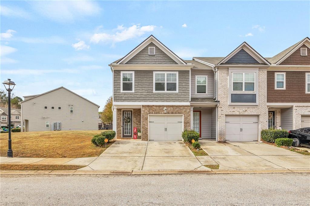 5011 Longview Walk Decatur, GA 30035 - Photo 1 of 26 a front view of a house with a yard and garage