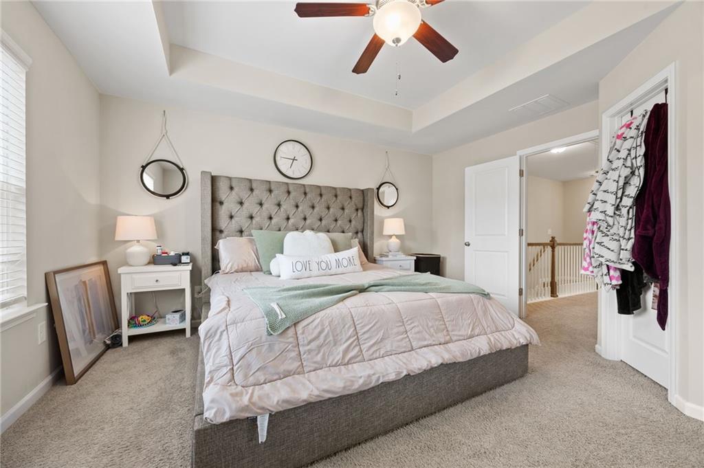 5011 Longview Walk Decatur, GA 30035 - Photo 17 of 26 a bedroom with a large bed and a chandelier