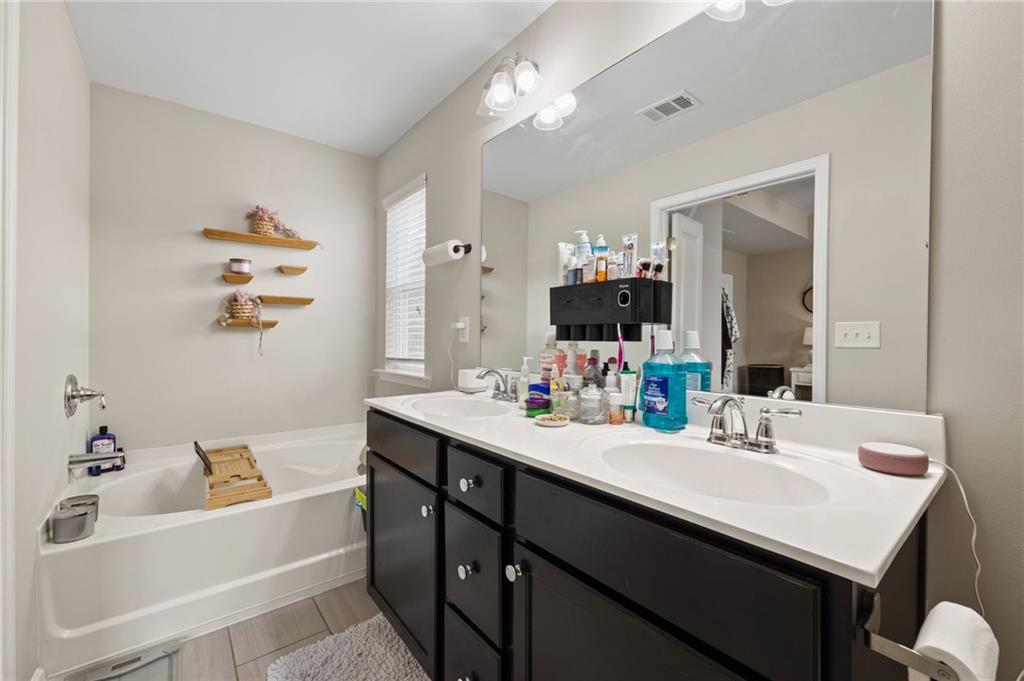 5011 Longview Walk Decatur, GA 30035 - Photo 19 of 26 a bathroom with a sink double vanity granite tub and a mirror