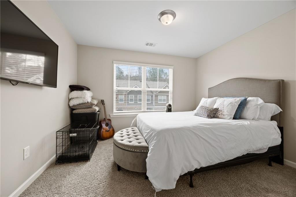 5011 Longview Walk Decatur, GA 30035 - Photo 20 of 26 a bedroom with a bed and a flat screen tv