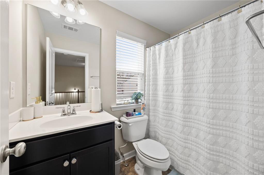5011 Longview Walk Decatur, GA 30035 - Photo 21 of 26 a bathroom with a sink a toilet and a mirror