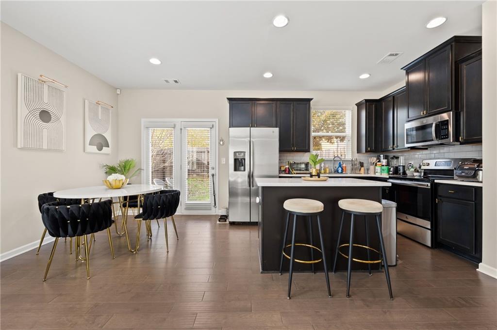 5011 Longview Walk Decatur, GA 30035 - Photo 9 of 26 a kitchen with a dining table chairs and refrigerator