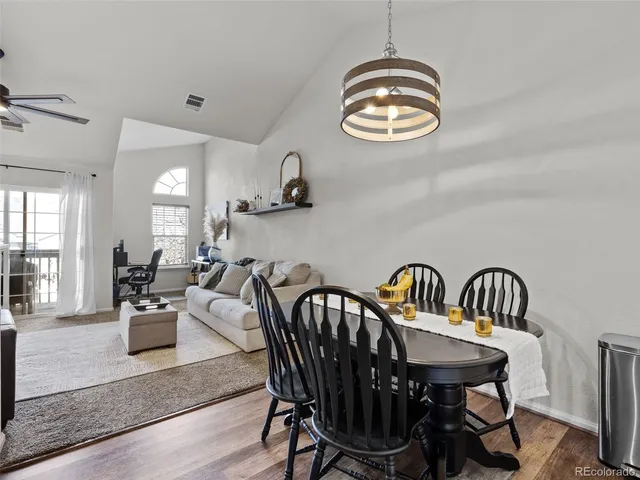 a living room with furniture a fireplace and a large window