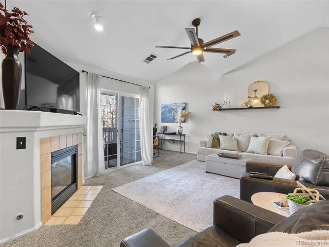 a living room with furniture and white wall