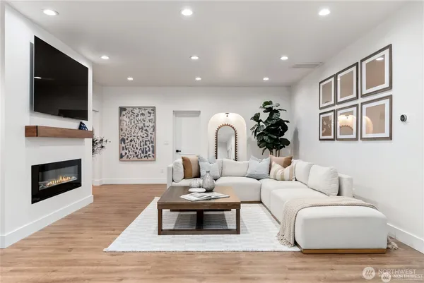 a living room with furniture a flat screen tv and a fireplace