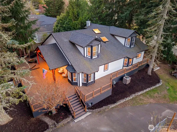an aerial view of a house with a yard