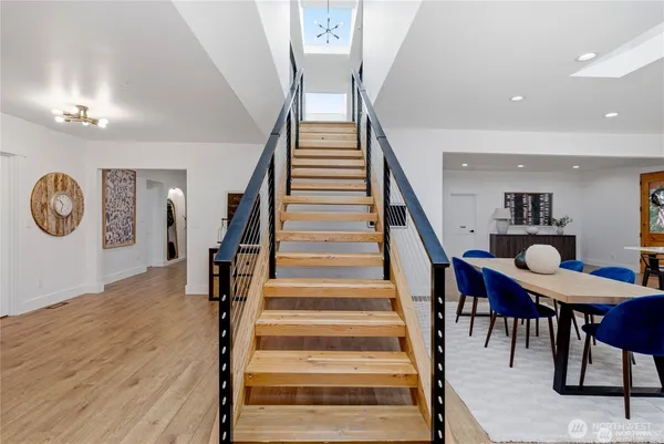 a view of entryway and hall with wooden floor