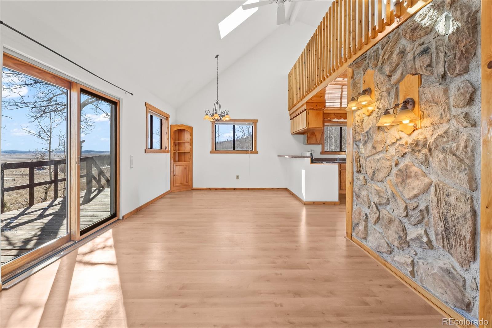 1793 Michigan Hill Road Jefferson, CO 80456 - Photo 12 of 44 a view of empty room with wooden floor and fan