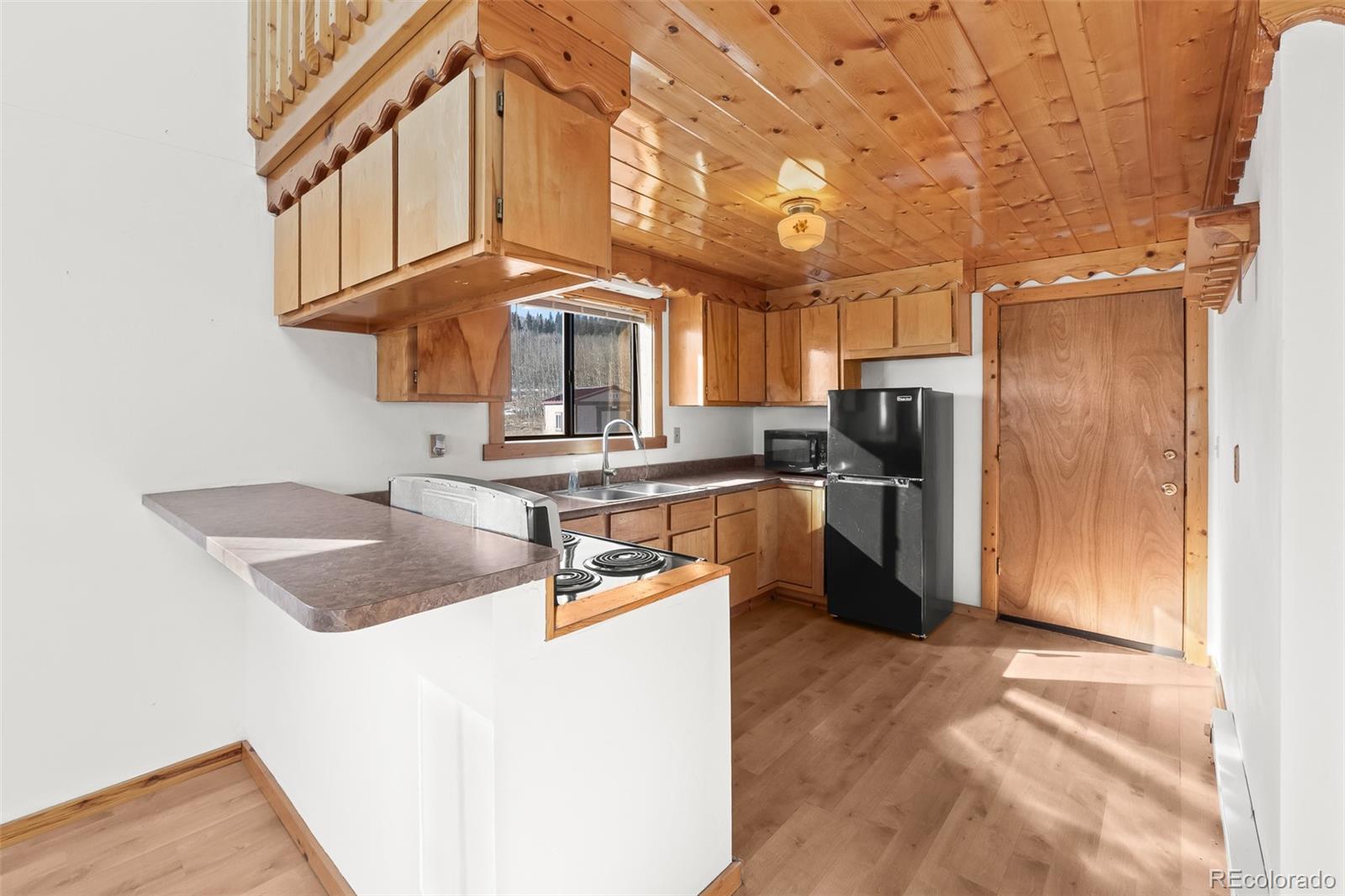 1793 Michigan Hill Road Jefferson, CO 80456 - Photo 18 of 44 a kitchen with stainless steel appliances granite countertop a sink a stove and a refrigerator
