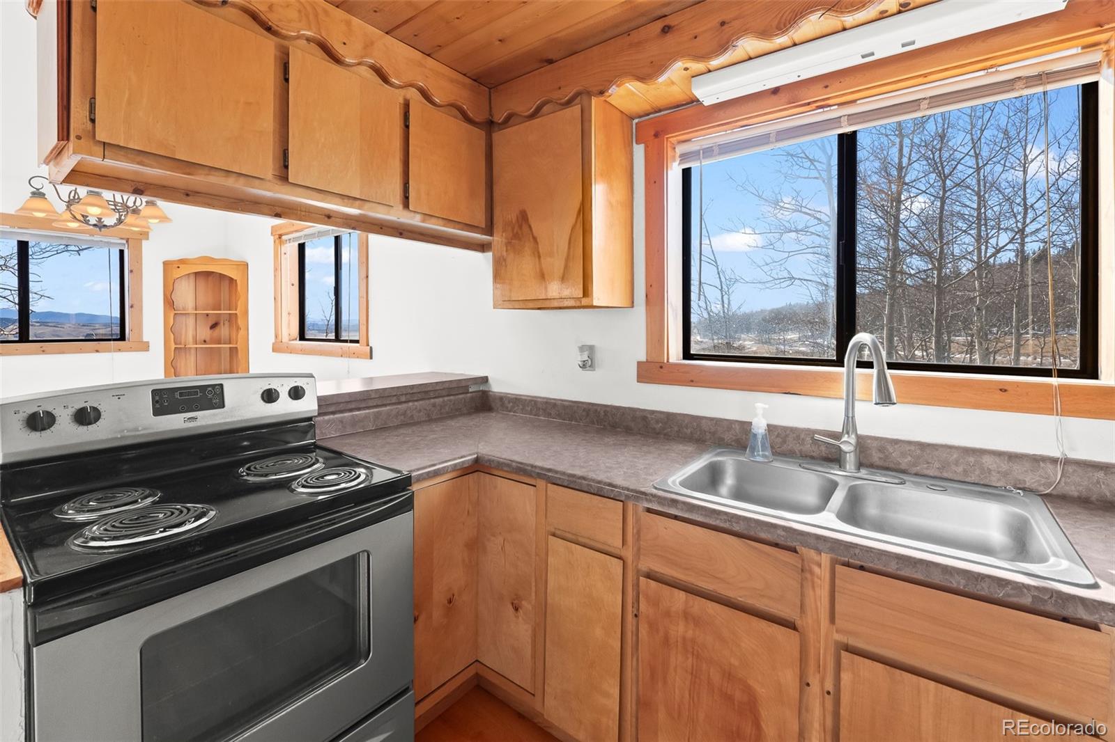 1793 Michigan Hill Road Jefferson, CO 80456 - Photo 20 of 44 a kitchen with granite countertop a sink stainless steel appliances and cabinets