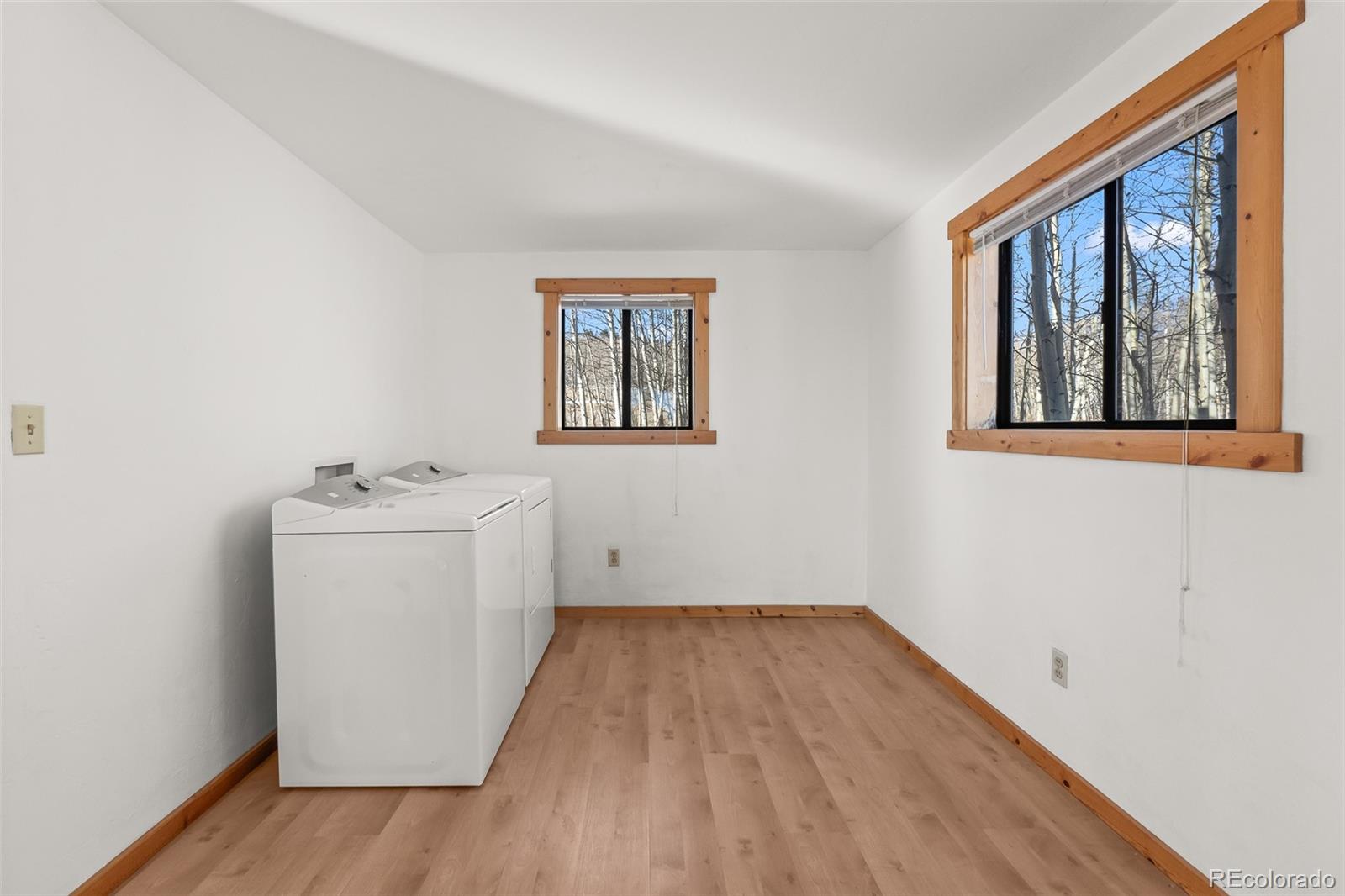 1793 Michigan Hill Road Jefferson, CO 80456 - Photo 23 of 44 a view of utility room with wooden floor and window