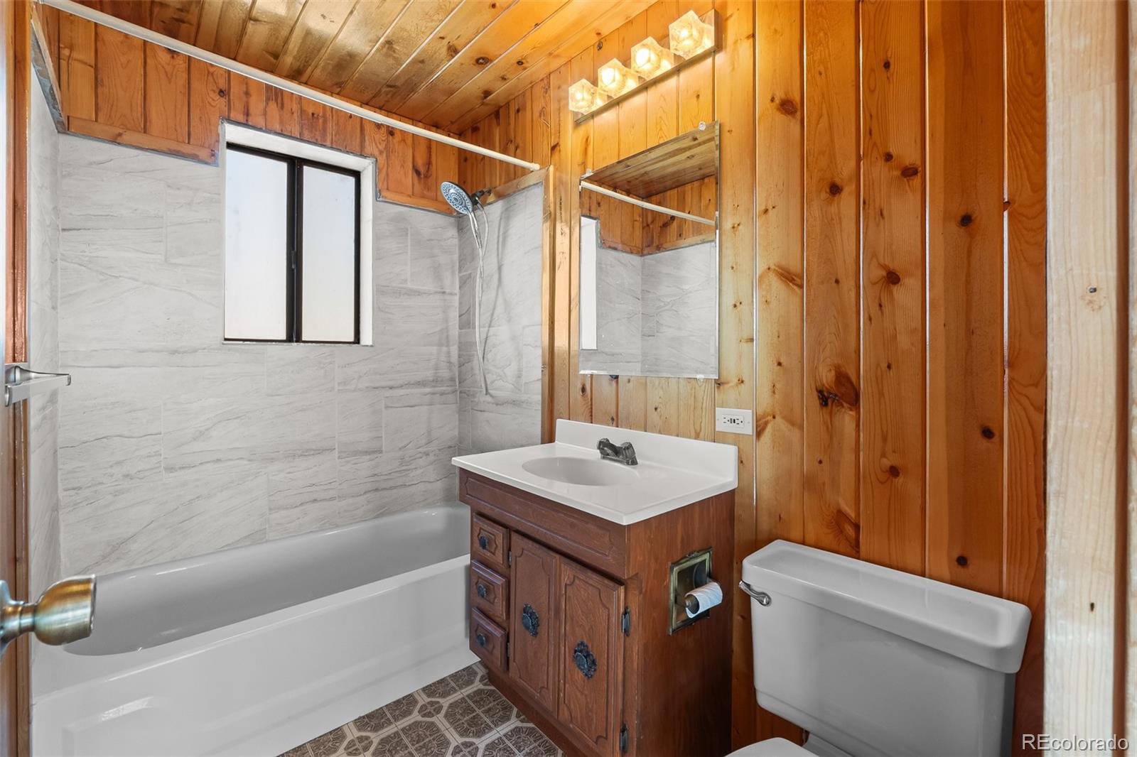 1793 Michigan Hill Road Jefferson, CO 80456 - Photo 25 of 44 a bathroom with a sink a toilet and shower