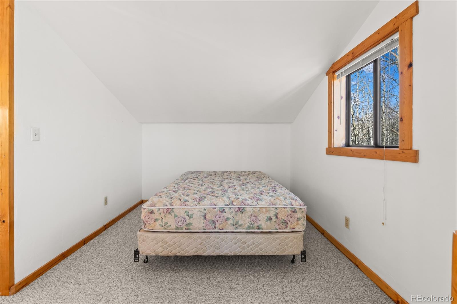 1793 Michigan Hill Road Jefferson, CO 80456 - Photo 27 of 44 a bedroom with a bed and a window