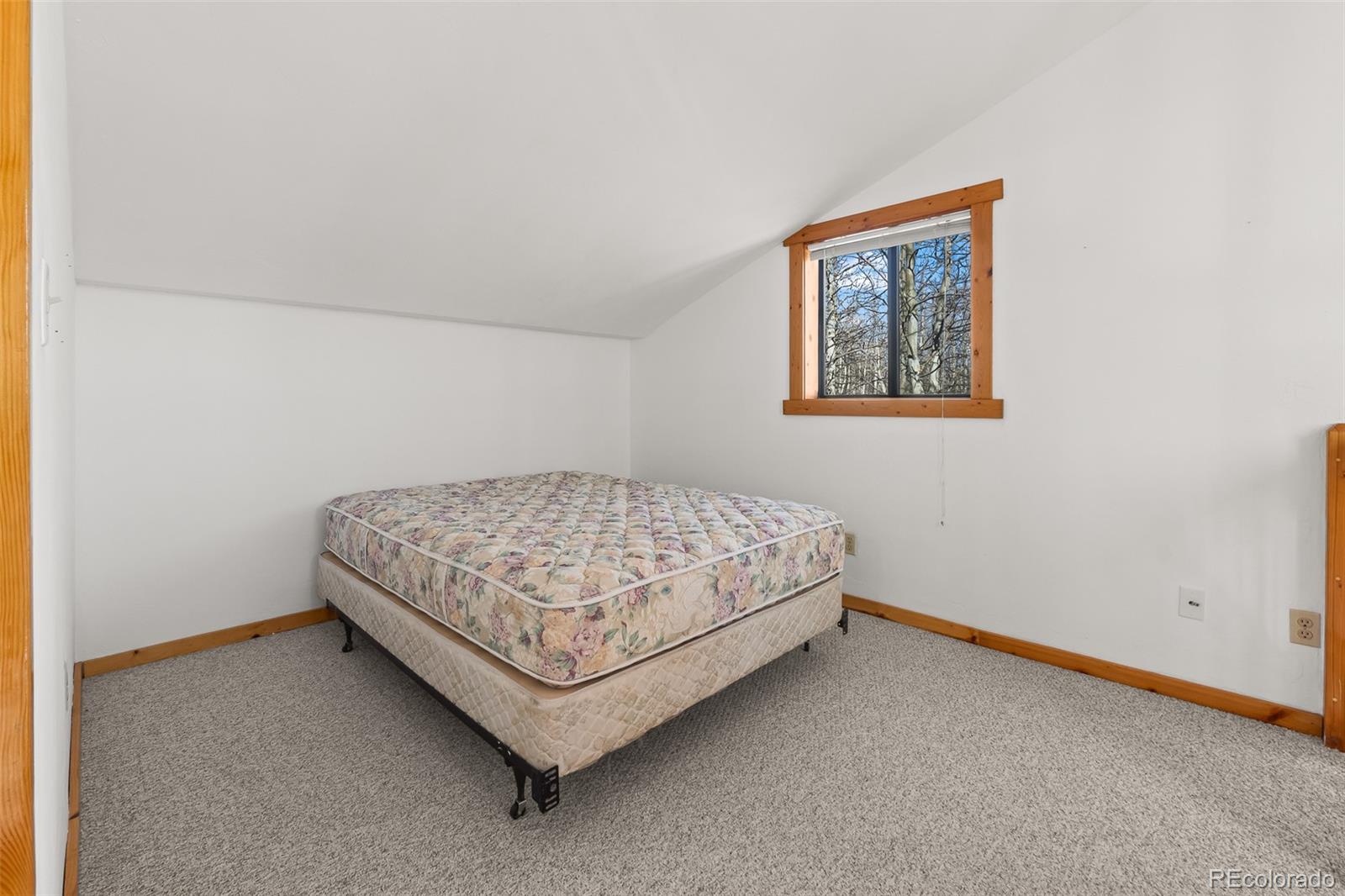 1793 Michigan Hill Road Jefferson, CO 80456 - Photo 29 of 44 a bedroom with a bed and painting on the wall