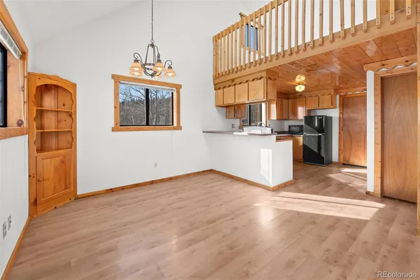 a kitchen with stainless steel appliances granite countertop a refrigerator a stove and a wooden floors