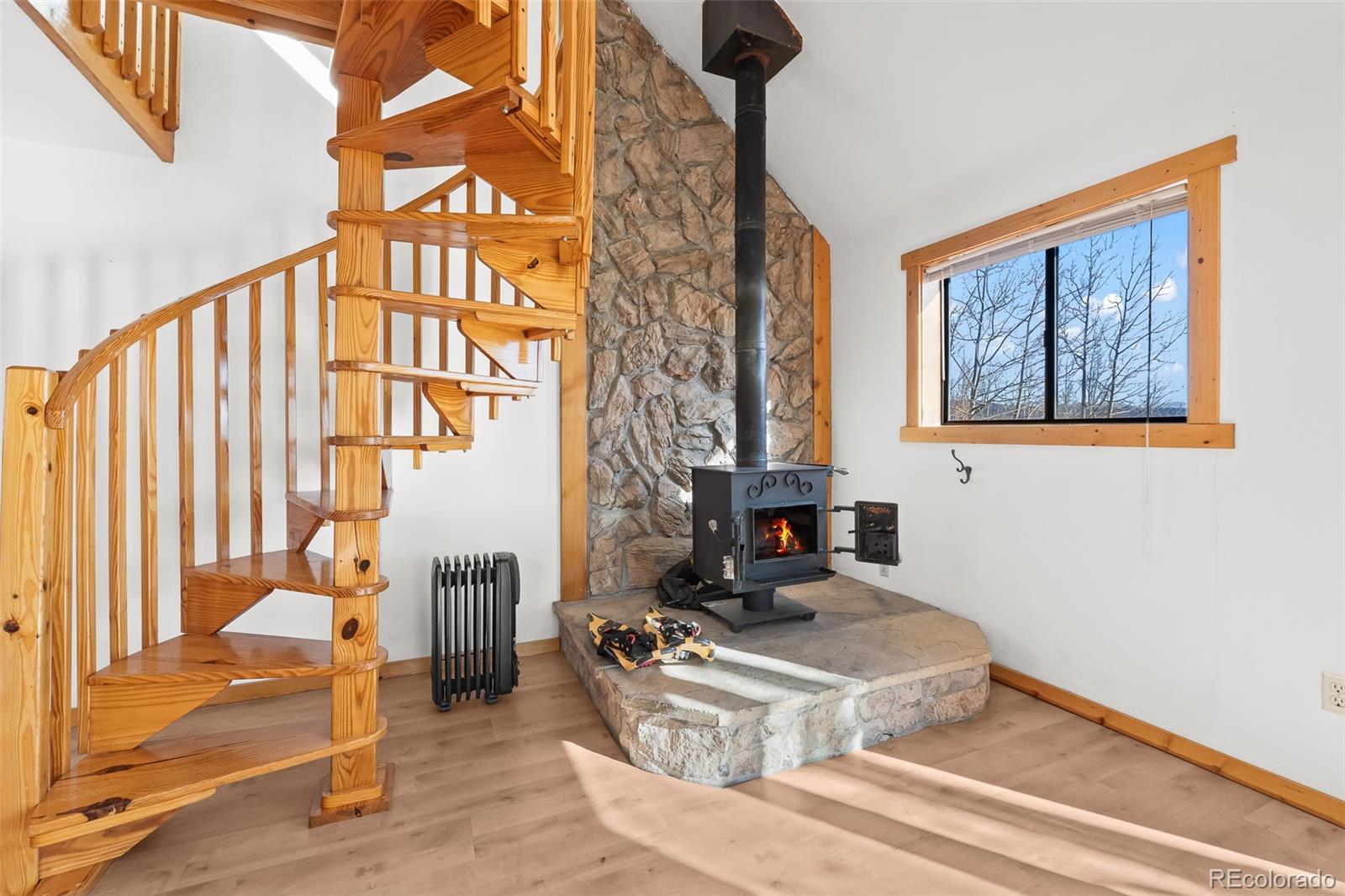 1793 Michigan Hill Road Jefferson, CO 80456 - Photo 10 of 44 a living room with furniture a rug and a window