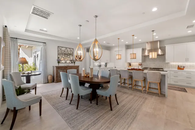 a view of a dining room with furniture and a floor to ceiling window