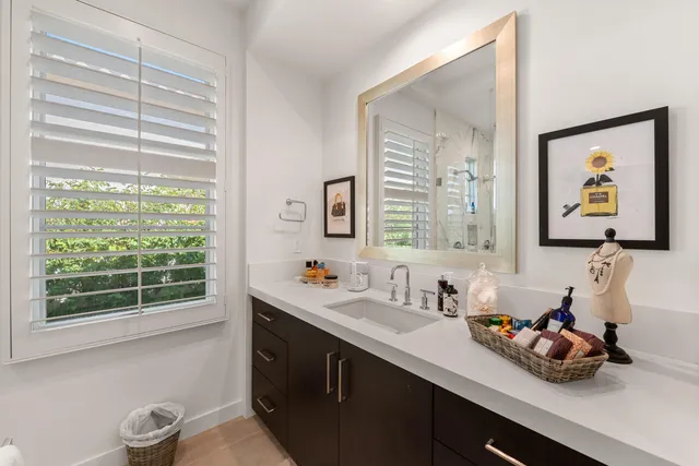 a kitchen with kitchen island a stove a table and chairs in it