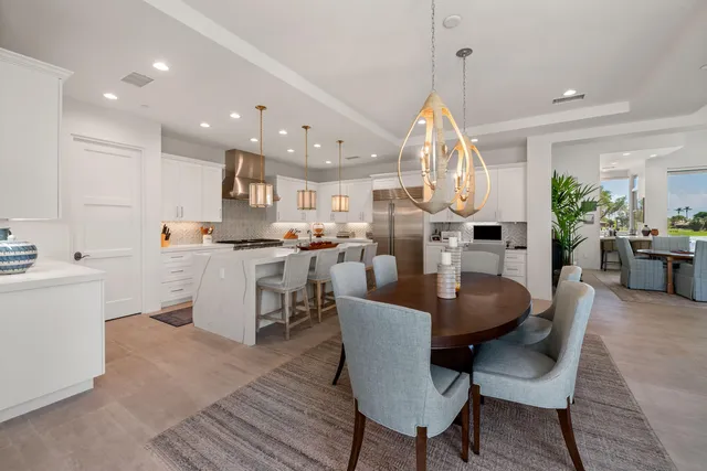 a kitchen with white cabinets and appliances